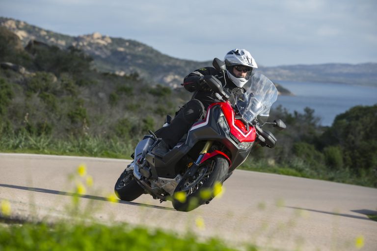 Honda X-ADV on a bend with the sea in the distance
