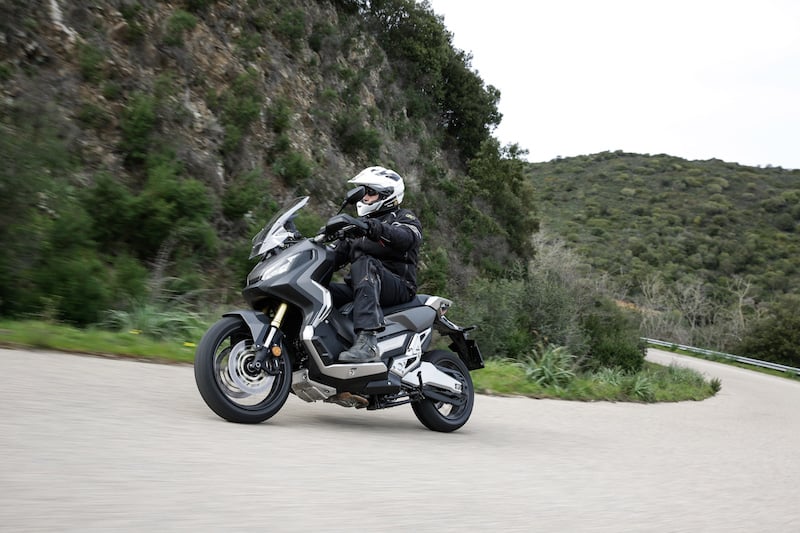 Honda adventure scooter on a road in Italy