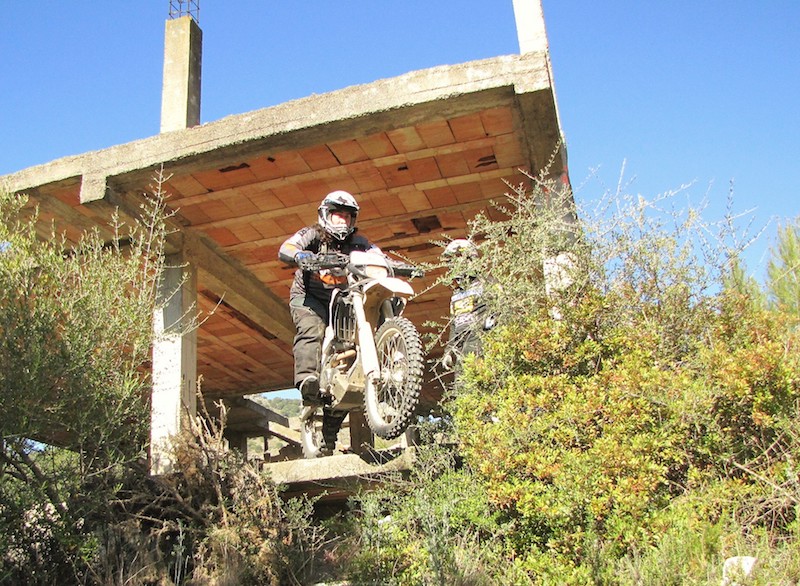 Riding a motorcycle down a steep bank