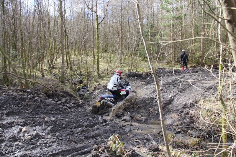 A Honda Africa Twin riding through mud