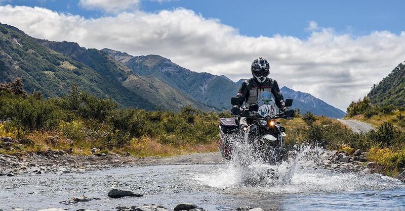 A motorcyclist crossing a river
