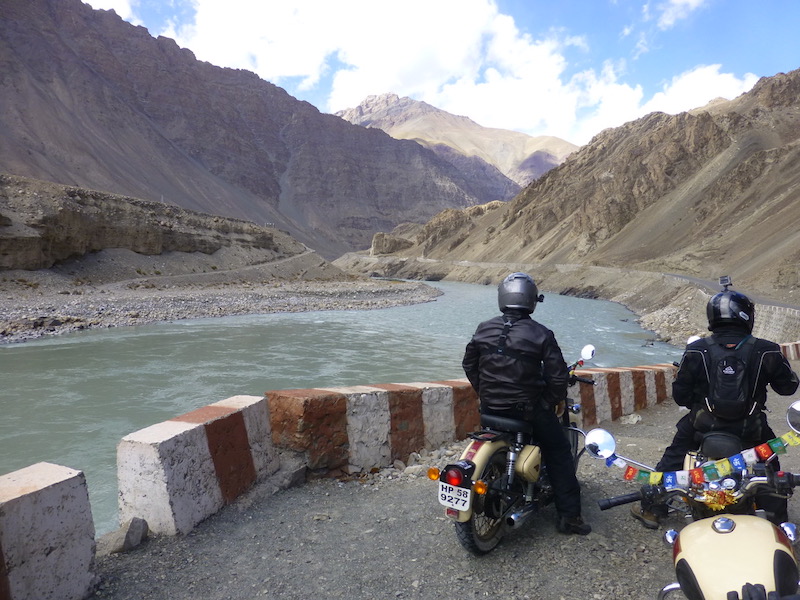 Motorcyclist river India mountains
