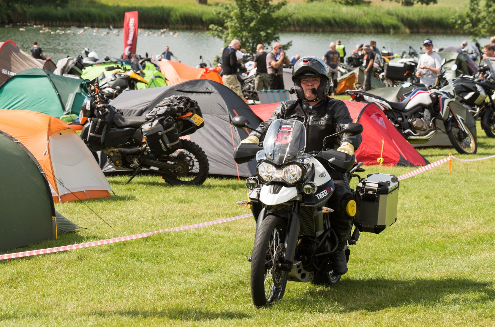 Man riding a Triumph Tiger while camping at the Adventure Bike Rider Festival