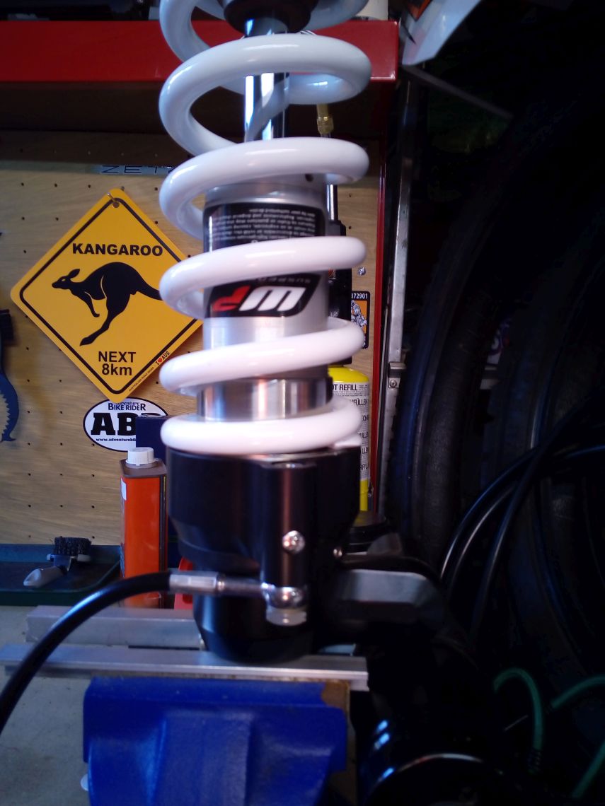 Rear suspension with new spring and hydraulic adjuster